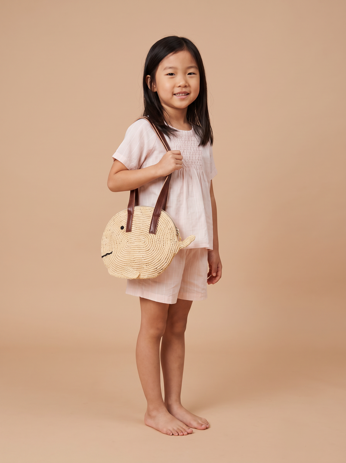 Sac poisson porté en bandoulière avec l ensemble rose